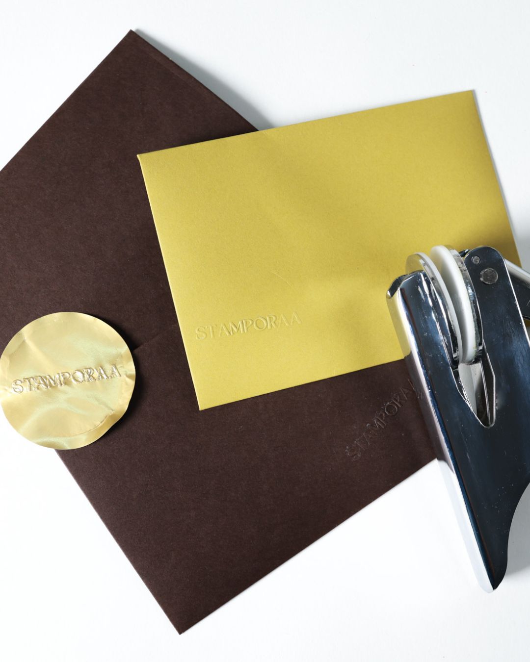 Paper embosser stamping on brown and yellow cards with zodiac seal