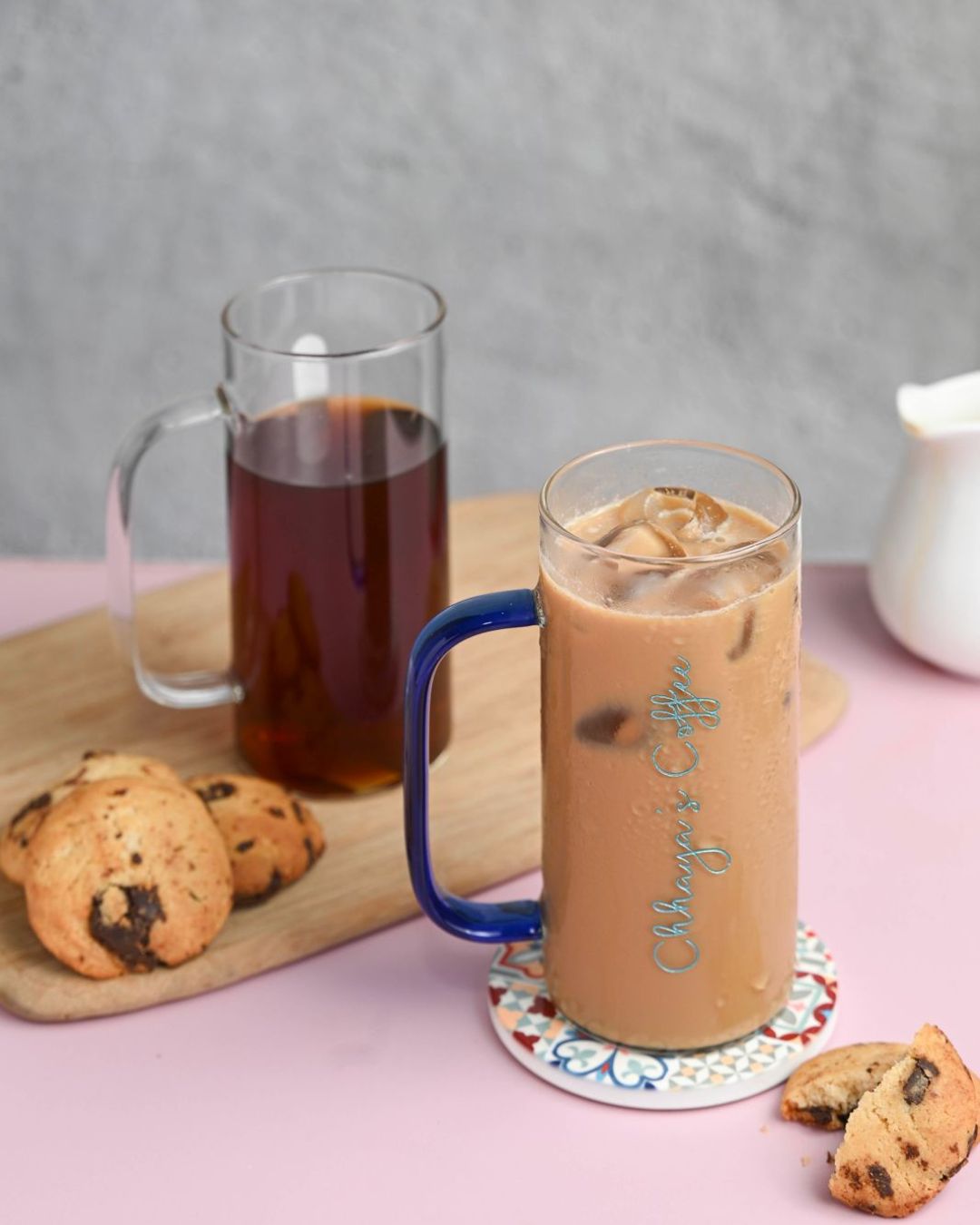 Tall glass with blue handle, custom engraved script, iced coffee with foam