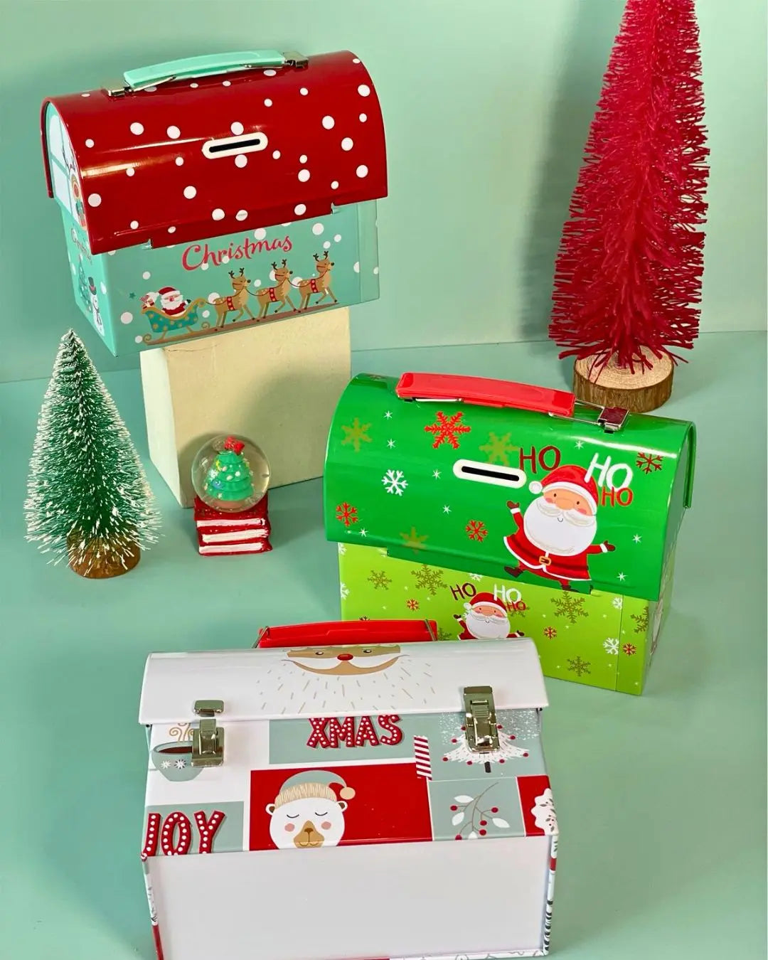 Santa-themed metal Christmas gift box with red lid and green front, festive HO HO design