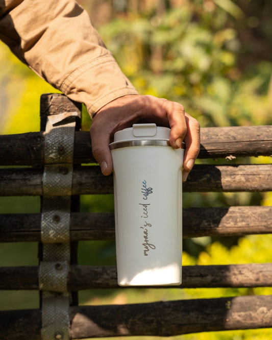 White smart thermal mug being lifted; personalized script visible on side