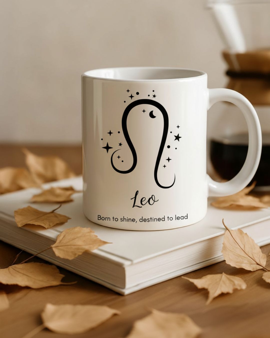 White horoscope mug with Leo zodiac design and caption 'Born to shine, destined to lead'