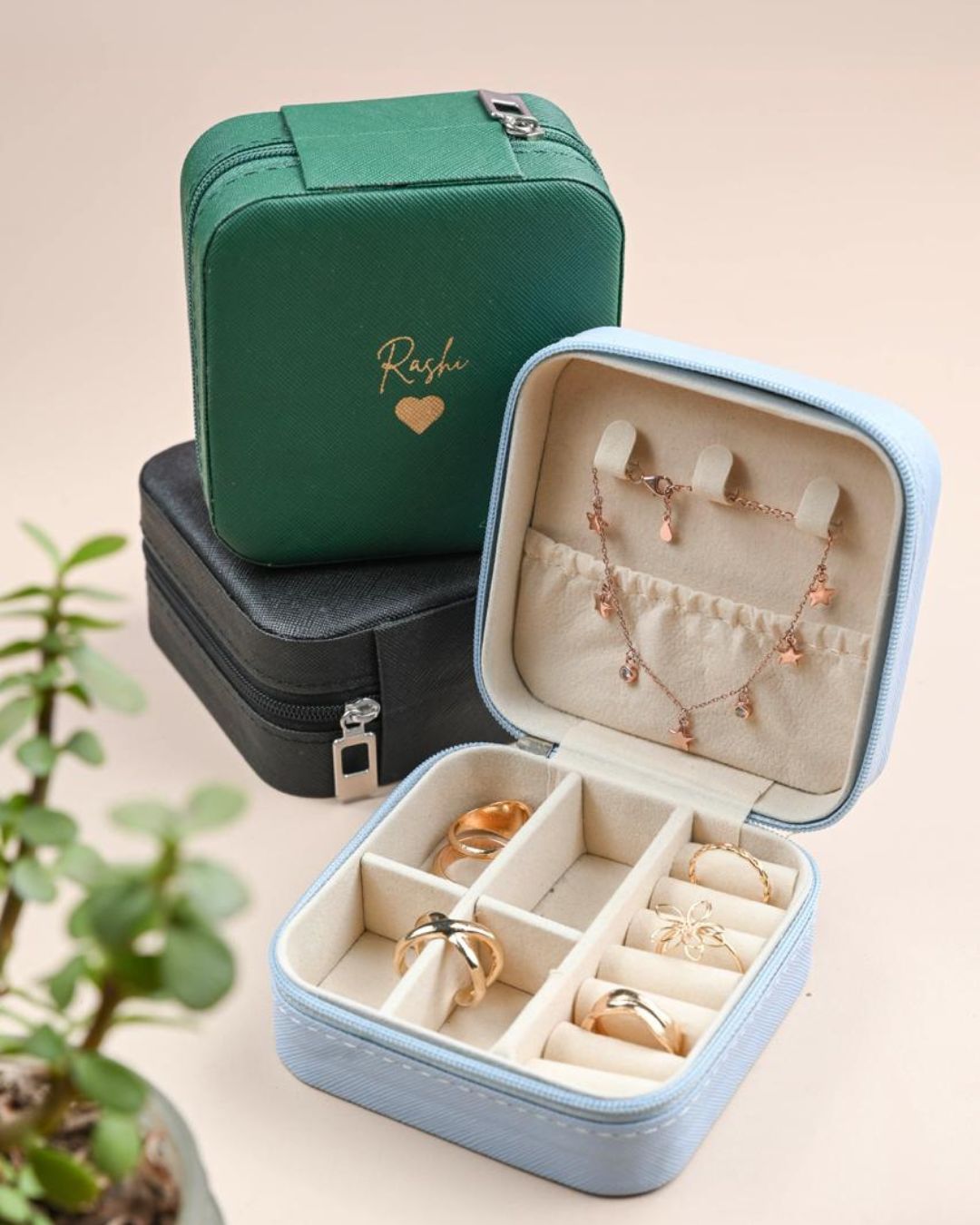Green organizer pouch and blue jewelry case with compartments for rings and earrings
