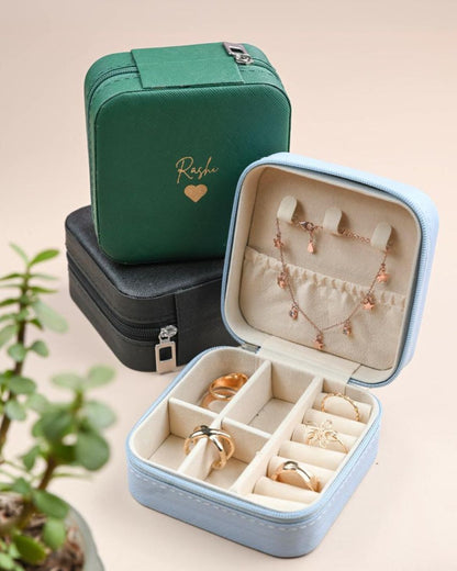 Green organizer pouch and blue jewelry case with compartments for rings and earrings