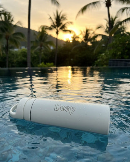 White handle water bottle with carry loop and 'Deep' logo, wet surface visible