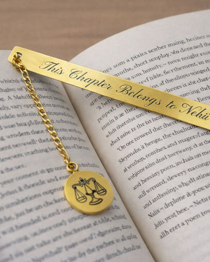 Gold metal bookmark “This Chapter Belongs to Nehi” with zodiac scales round pendant