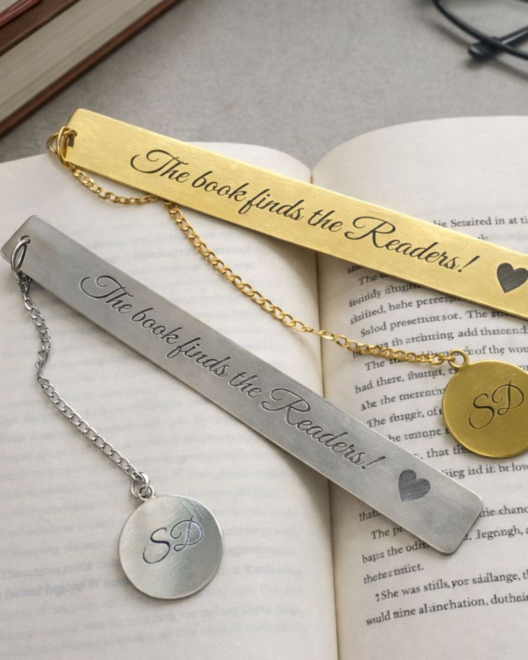 Gold and silver metal bookmarks with heart insets and round monogram pendants