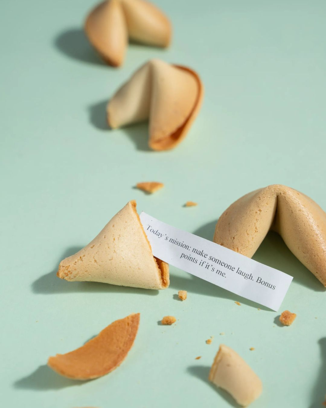 Personalized fortune cookies with printed fortune slips and broken halves