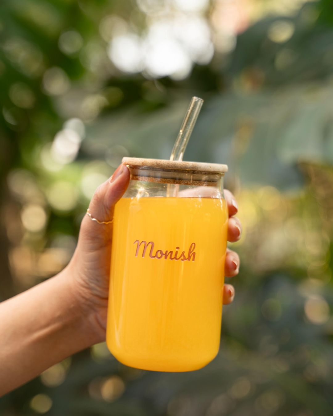 Personalized can glass with straw, amber drink, 'Monish' engraving