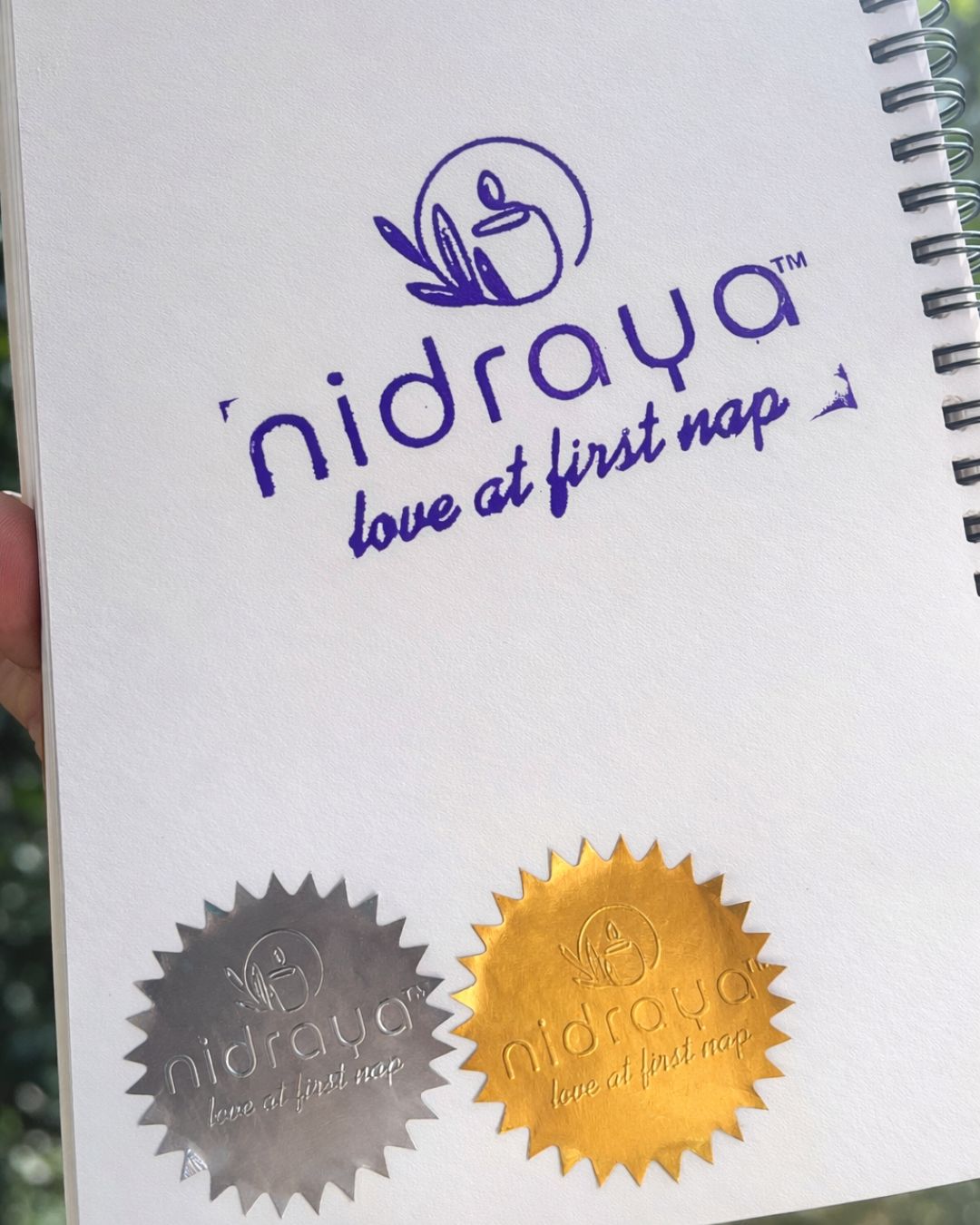 Personalized notebook cover with blue name print and two circular seal designs