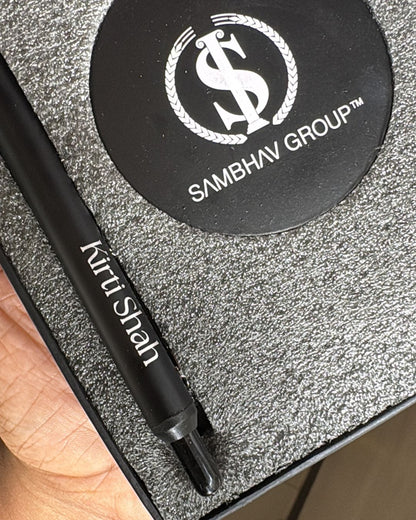 Signature Shaan Set: close-up of black pen and silver glitter logo coaster